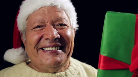 Merry Aged Man With Santa Hat Showing A Green Gift Stock Footage 44446755