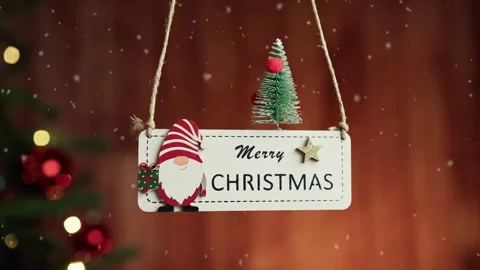 Merry Chistmas patch hanging with decorated tree in the background Vídeos de archivo 254393081