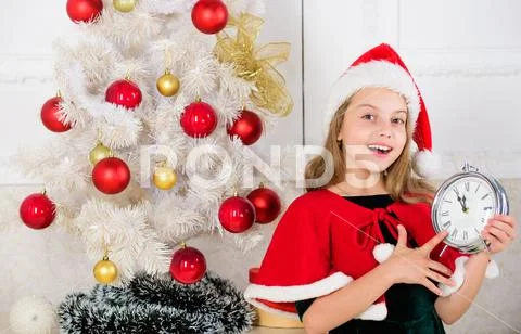 Merry christmas concept. New year countdown. Girl kid santa hat costume hold Stock Photos
