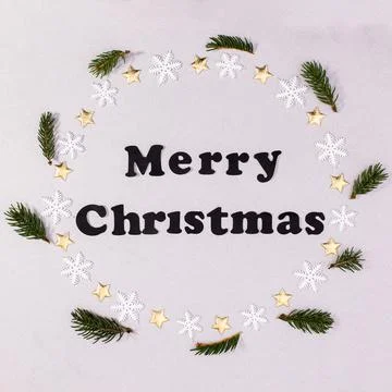 Merry Christmas creative background with text in round border with fir branch Stock Photos