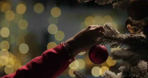 Merry Christmas New Year decoration. Kid decorating Christmas tree with balls on Stock Footage 293491237