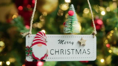 Merry Christmas patch Hanging from a Christmas tree 스톡 동영상 257430306