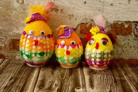 Merry Easter eggs disguised in colourful crochet suit like dad, mom and baby Stock Photos