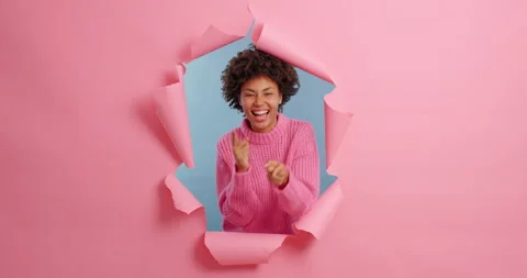 Merry friendly woman points at camera and says hey you picks someone has joyful Stock Footage 143171381