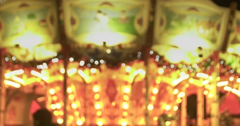 Merry go round carousel at the carnival lights up! 4K Stock Footage 57979324