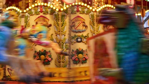 Merry go round carousel fairground ride at night fair or funfair Stock Footage 98142279