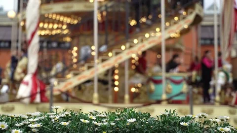 Merry-go-round carousel. Happy kids with parents riding carousel and taking Stock-Footage 81531699