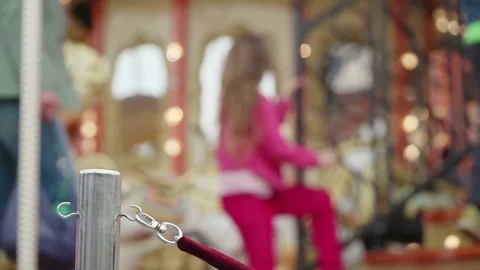 Merry-go-round carousel. Happy kids with parents riding carousel and taking Stock Footage 83603532