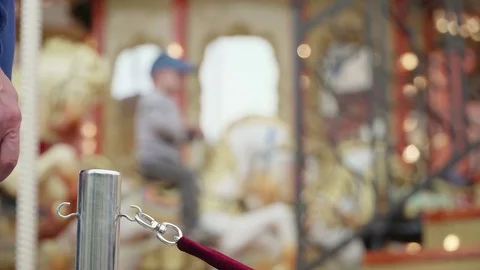 Merry-go-round carousel. Happy kids with parents riding carousel and taking Stock Footage 83945162