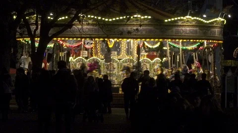 Merry-go-round carousel lit up at night with large crowd in london, england Stock Footage 86856786