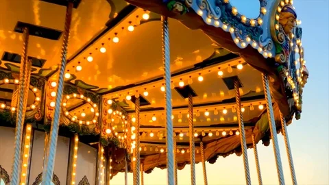 A merry-go-round, or crousel spinning at sunset. Video stock 123865004