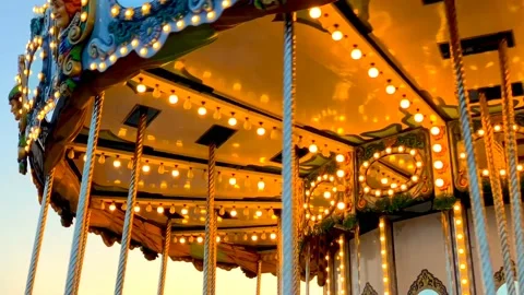 A merry-go-round, or crousel spinning at sunset. Video stock 123865032