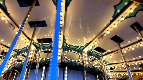 A merry-go-round, or crousel spinning at sunset. Video stock 123865057