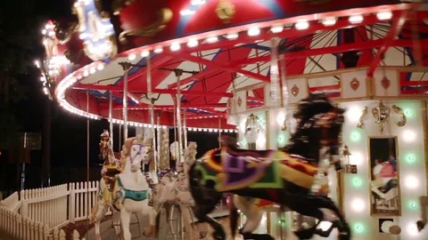 Merry go round turning at night Stock Footage