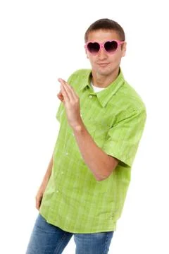 Merry portrait of a young man in a ridiculous pink sunglasses Stock Photos