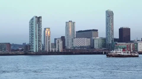 Mersey ferry passing apartment blocks, liverpool at dusk Stock Footage