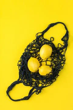 Mesh bag with lemons. Zero waste, plastic free concept Stock Photos