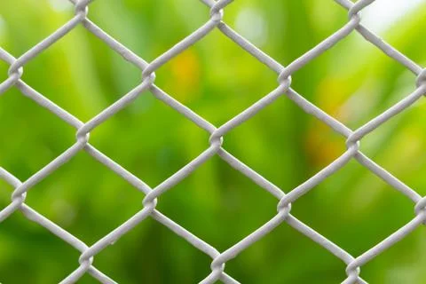 Mesh fence closeup on blur backgroun Stock Photos
