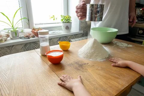 Mesh flour sifter working in cook s hand. Background with free copy text spac Stock Photos