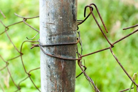 Mesh pattern.The chain-link fence.background. Wire mesh and old wrought iron. Stock Photos