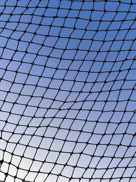 Mesh Sky. Geometric Net Against Blue Sky Stock Photos