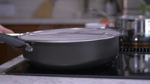 Mesh Splatter Guard on Hot Pan Video stock 97300034