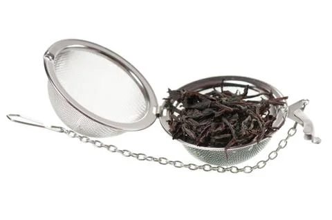 Mesh tea infuser ball filled with black tea Stock Photos