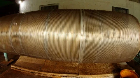 Mesh tube rotates process of sifting tea manufacture on old factory Stock Footage 98757818