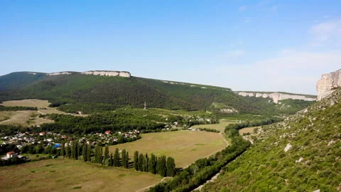 A mesmerizing aerial view from a drone of a valley surrounded by mountains Stock Footage 157821433