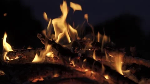 The mesmerizing and captivating flames dance gracefully over the logs in a cozy Stock Footage 317024518