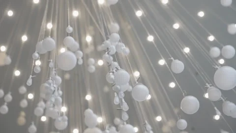 A mesmerizing array of suspended white orbs and glowing lights creates a Stock Footage 310351829