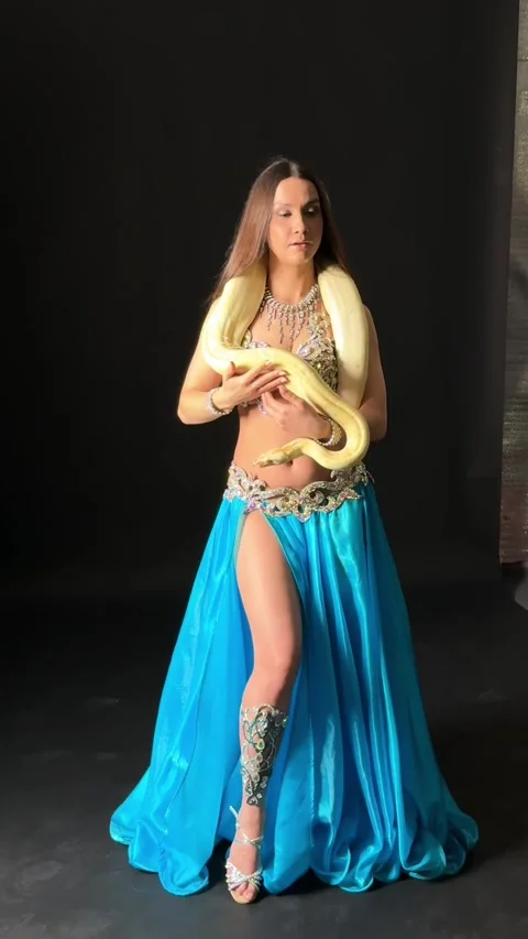 Mesmerizing Belly Dancer with Snake in Studio Footage Stock Footage 329150191