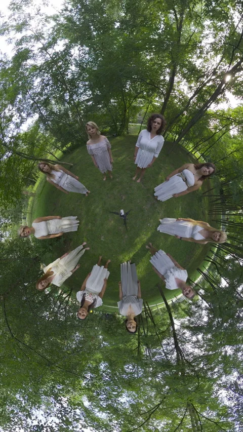 Mesmerizing Birds Eye View of a Circle of 11 Women in White Dresses Singing in a Stock Footage 285848824