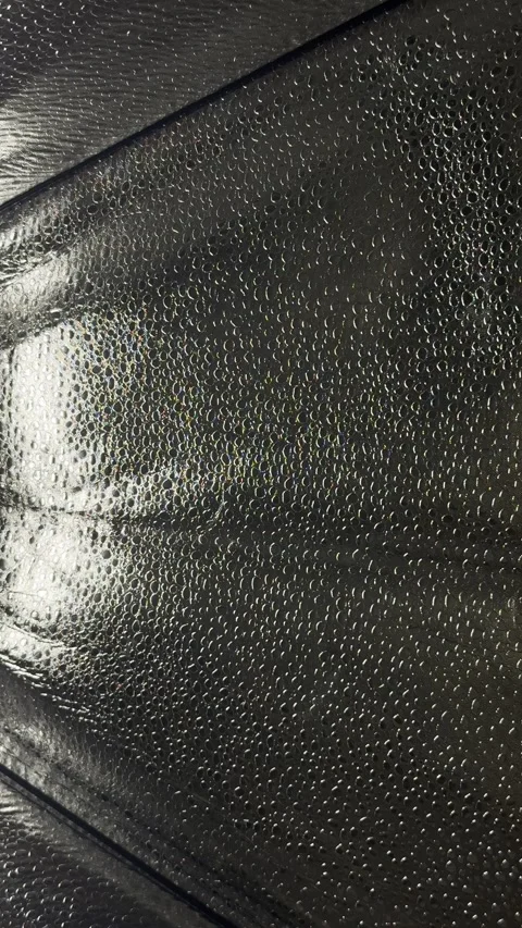 Mesmerizing black iridescent bubble texture closeup panning shimmering holograph Stock Footage 327637288