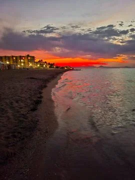 Mesmerizing bright orange sunset over the Mediterranean Sea in Denia, Spain.. Stock Photos