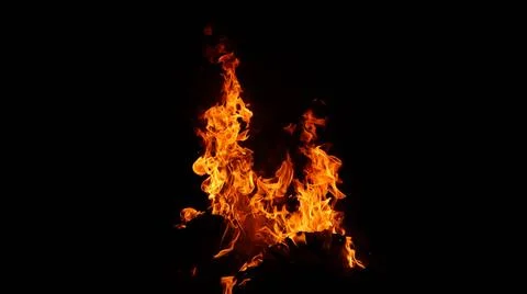 A mesmerizing close-up of a blazing fire against a dark background Foto stock