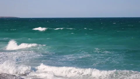 A mesmerizing close up of turquoise ocean waves crashing and foaming on a beach Stock Footage 318823624