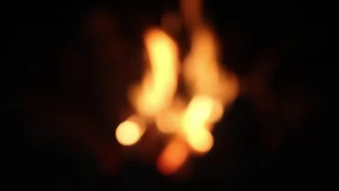 A mesmerizing display of flames flickers in the darkness, creating a warm glow Video stock 292756119