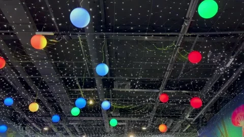 Mesmerizing display: a starry ceiling twinkles with colorful balls, evoking a ce Stock-Footage 264292165