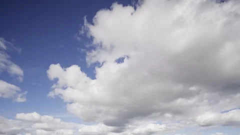 The mesmerizing flow of time as clouds move across vibrant blue skies in this 스톡 동영상 330813373