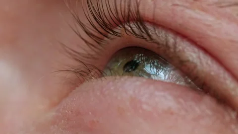 A Mesmerizing Gaze: A Close-Up of a Person's Eye with Long Lashes 動画素材 256245510