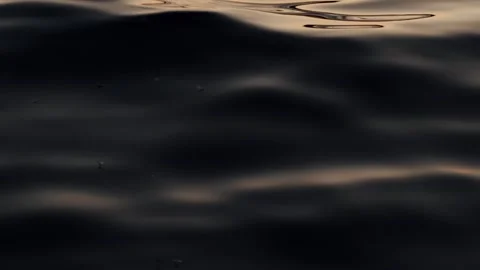 Mesmerizing Golden Hour Close-up of Calm Water Surface with Gentle Ripples Stock Footage 346897177