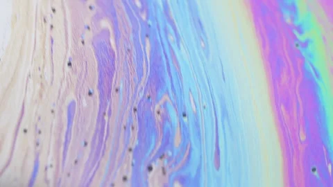 Mesmerizing iridescent soap bubble surface with swirling colors and dark spots Stock Footage 332167381
