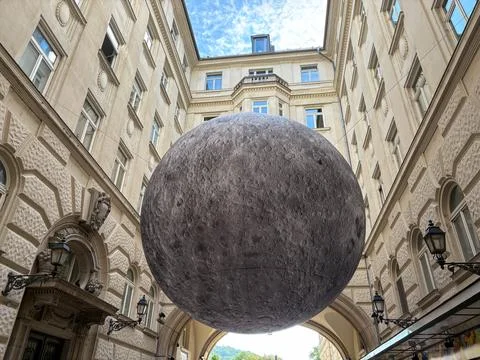 A mesmerizing large-scale moon installation in the courtyard of a complex Stock Photos