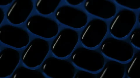 Mesmerizing light reflections dancing on perforated stainless steel sheet with Stock Footage 311582770