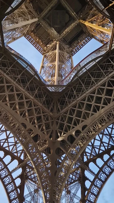 A mesmerizing look up into the intricate iron heart of the Eiffel Tower, through Stock Footage 325048201