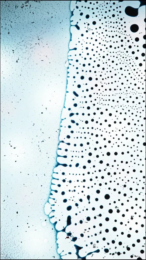 Mesmerizing Macro View of Liquids Mixing in a Unique Vertical Pattern Stock Footage 329538180