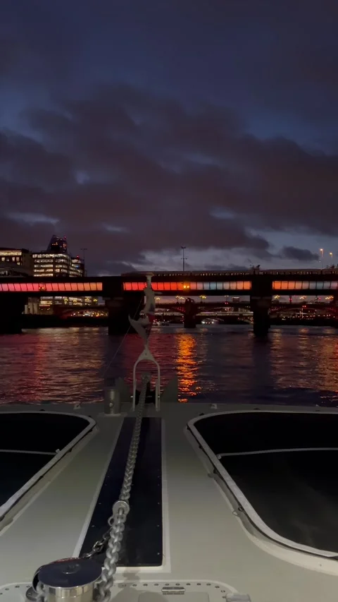 A mesmerizing night passage beneath a vividly lit bridge, viewed from a boa.. Stock Footage 339390813