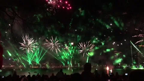 A mesmerizing night show illuminates the sky and water Stock Footage 312679030