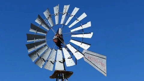 Mesmerizing Old Western Windmill Spinning in Gusty Winds Stock Footage 82100572